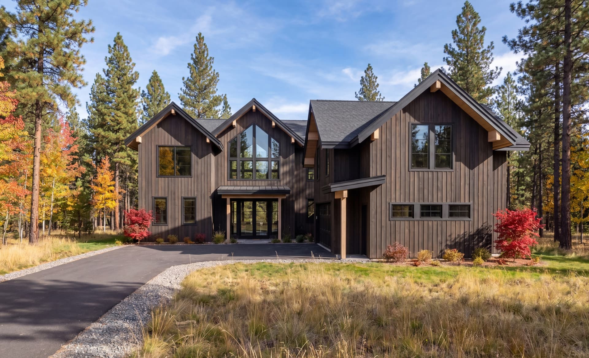 Suncadia house design — driveway approach to a low horizontal home in fall color near Cle Elum